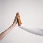 Two hands touching, symbolizing connection and diversity.